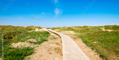 Obraz na płótnie A wooden boardwalk from Sola Strand Hotel to the beach, Stavanger, Norway, May 2018 w salonie