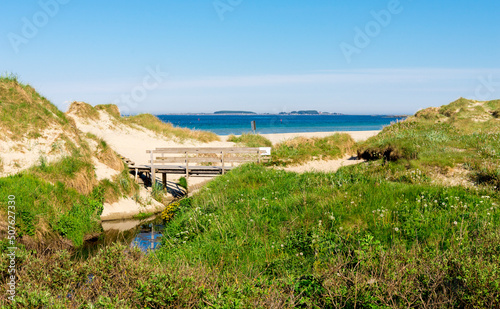 Obraz na płótnie A small wooden bridge over a narrow stream at the entrance to Sola beach, Stavanger, Norway, May 2018 w salonie