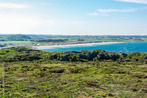 Obraz na płótnie A distant view to beautiful long Hellestostranden white sand beach while hiking along the North sea coast, Stavanger city, Norway, May 2018 w salonie