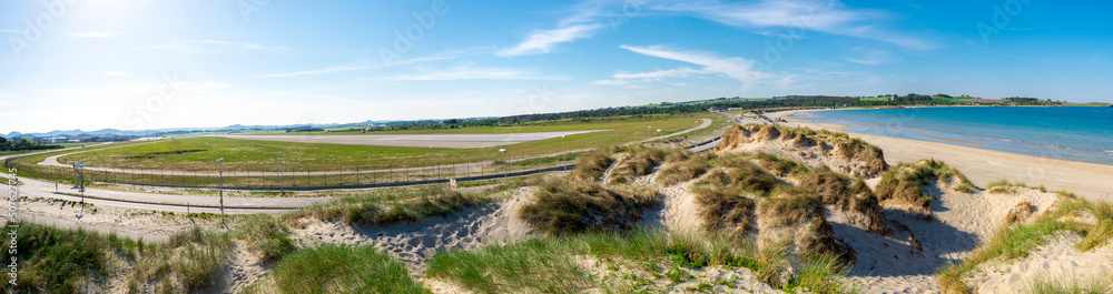 Panoramic view to Sola airport runaway near the white sand beach strip, Stavanger, Norway, May 2018