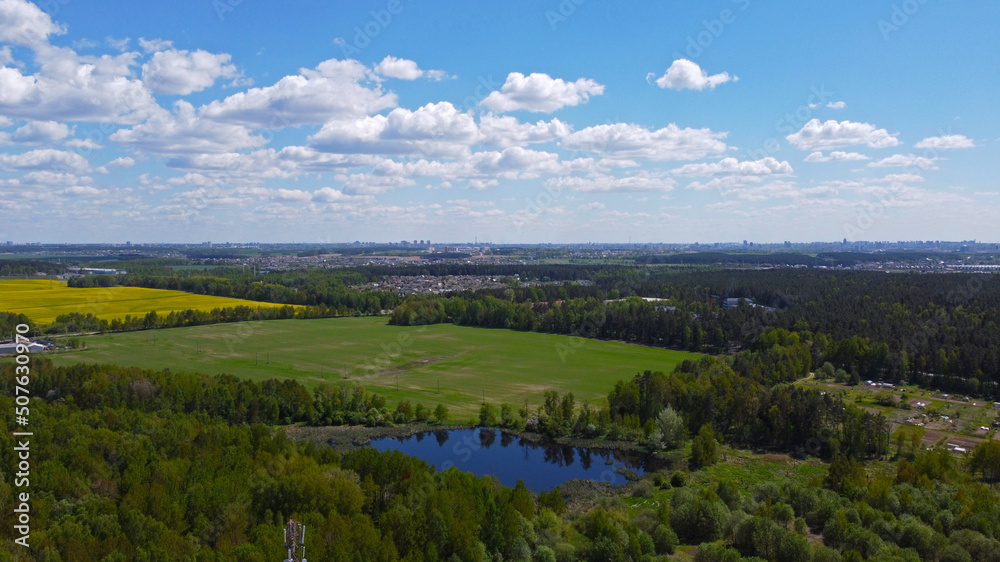 Aerial view of a green rural landscape with forests and meadows