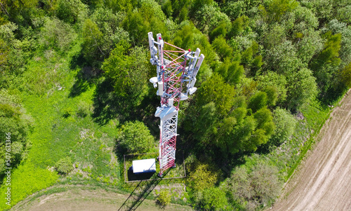 Aerial view of the tower of mobile communications, telecommunications and the 5g Internet. An iron head with locators and antennas. 25 May 2022, Minsk, Belarus
