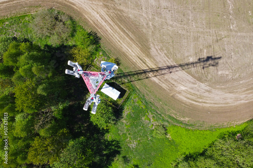Aerial view of the tower of mobile communications, telecommunications and the 5g Internet. An iron head with locators and antennas. 25 May 2022, Minsk, Belarus