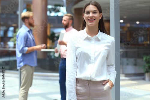 business woman with her staff, people group in background at modern bright office indoors