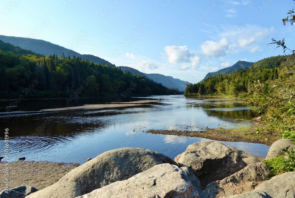 Jacques-Cartier National Park in province of Quebec, Canada, with green foliages, rocks and mountains at the water’s edge of the Jacques-Cartier River Jacques-Cartier National Park in province of Quebec, Canada, with green foliages, rocks and mountains at the water’s edge of the Jacques-Cartier River