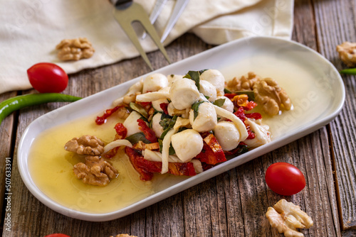 Specially prepared breakfast cheese. A special cheese plate prepared with olive oil, vegetables, walnuts and cheeses. close up photo