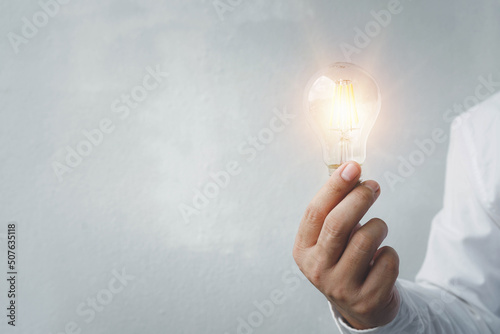 hand holding light bulb. idea concept with innovation and inspiration, ideas of new ideas with innovative technology and creativity. ideas creativity concept holding light bulb.	