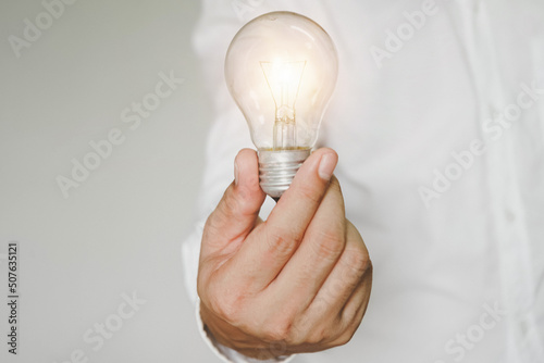 hand holding light bulb. idea concept with innovation and inspiration, ideas of new ideas with innovative technology and creativity. ideas creativity concept holding light bulb. 