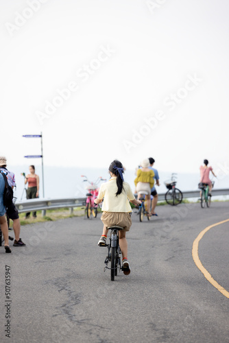 people riding bicycles, playing and exercising on vacation On the road and see the beautiful nature Thailand Dates 28-5-2022