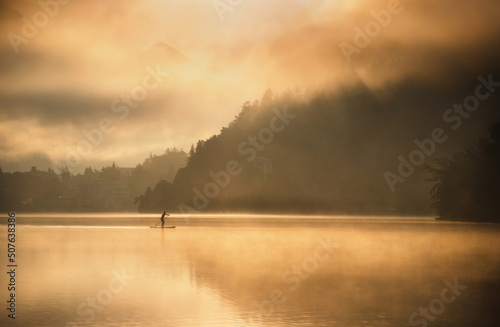Lake Bled on a misty summer morning on a colorful sunrise