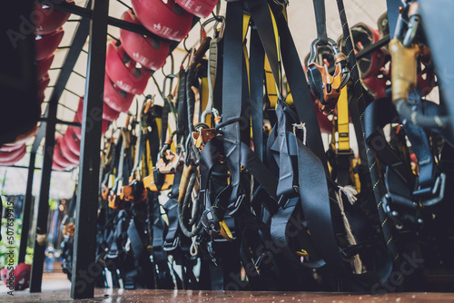 Rows of climbing safety ropes and carabiners and helmets