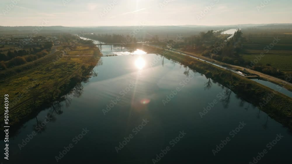 Flying forward on top of the river near the water, with the reflection of the sun in the blue water. Beauty in nature. Flying forward on top of the river near the water, with the reflection of the sun in the blue water. Beauty in nature.