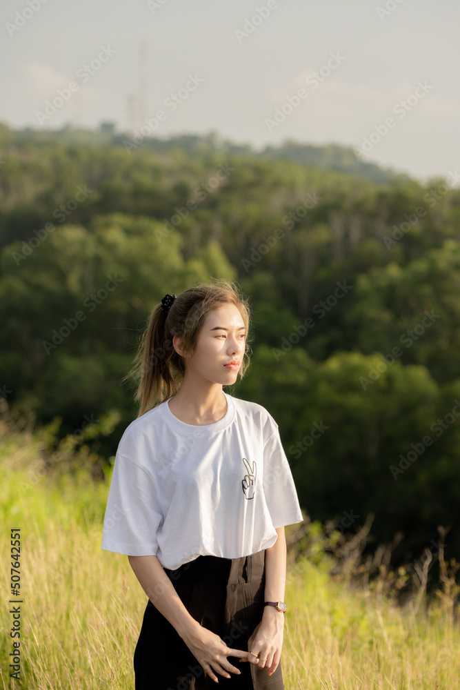 cute girl standing and playing with beautiful nature with clear sky on vacation They stood and took pictures happily. cute girl standing and playing with beautiful nature with clear sky on vacation They stood and took pictures happily.