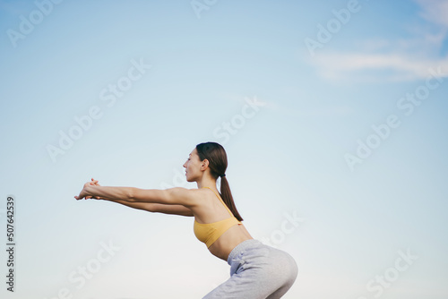 Cute girl training on a sky backgroung