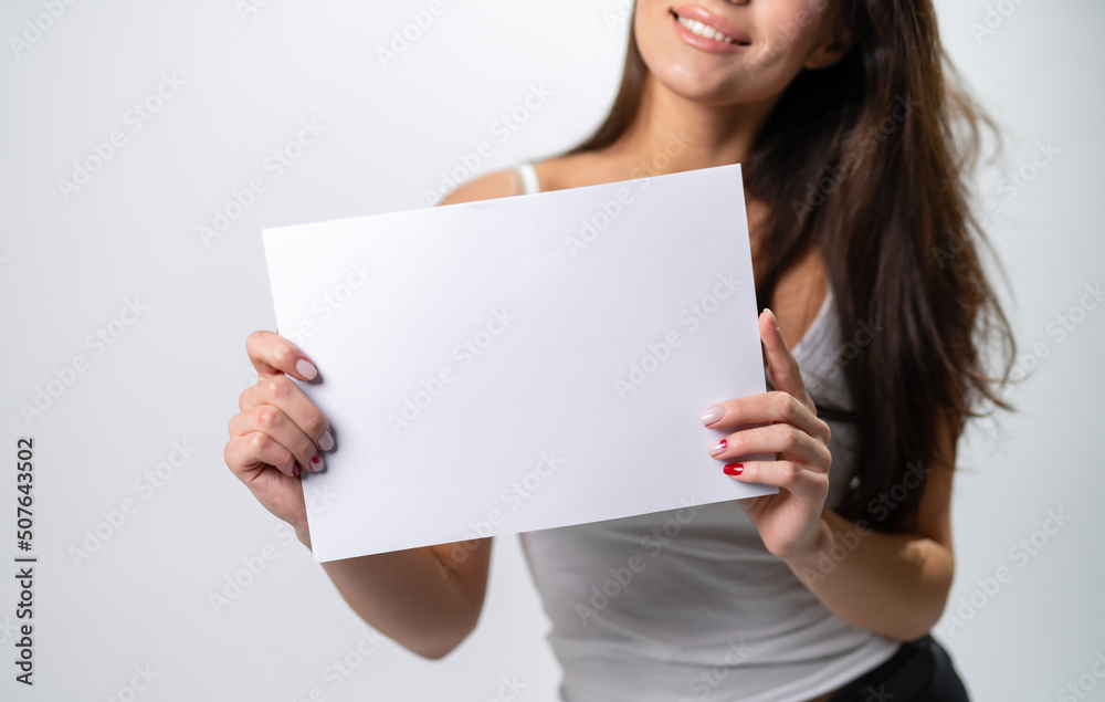 Pretty model with empty banner sign. Young lady showing white paper. Pretty model with empty banner sign. Young lady showing white paper.