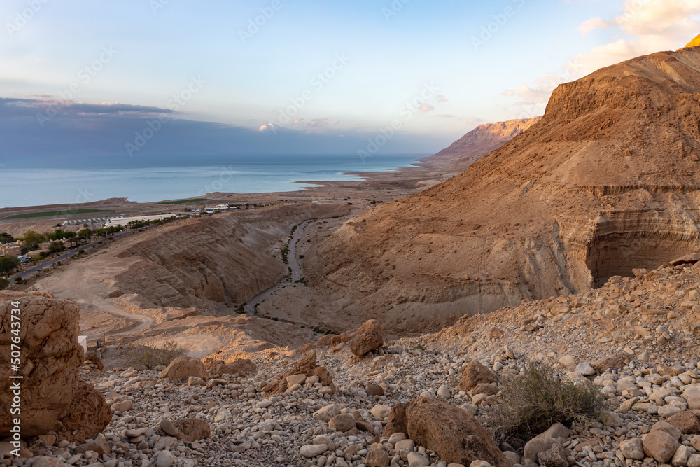Sunrise  over the Dead Sea near mountains of stone desert near the Khatsatson stream, on the Israeli side of the Dead Sea, near Jerusalem in Israel