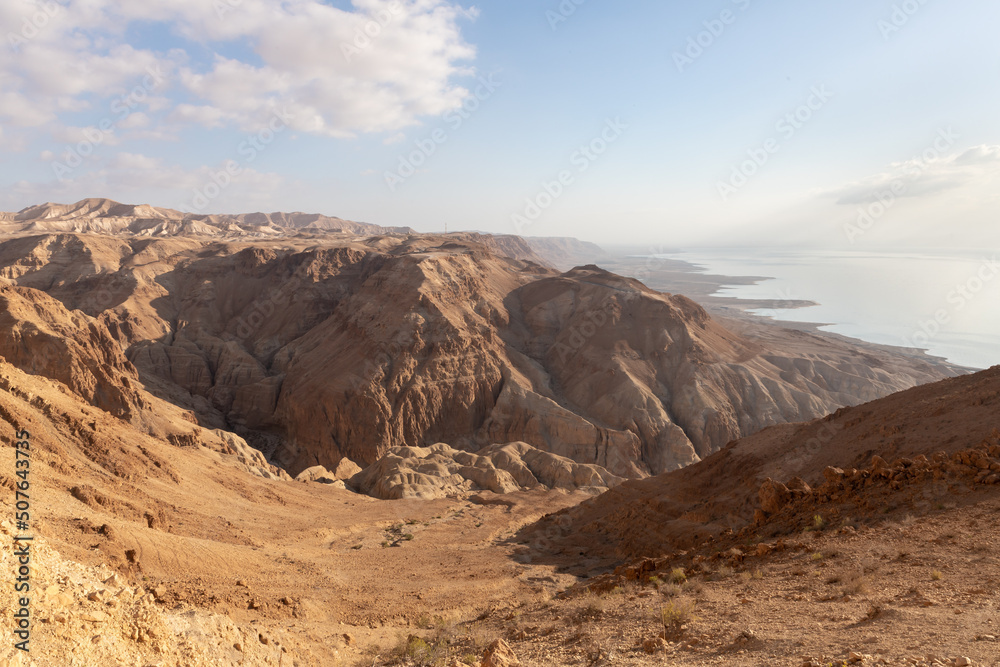 Obraz premium Sunrise over the Dead Sea near mountains of stone desert near the Khatsatson stream, on the Israeli side of the Dead Sea, near Jerusalem in Israel