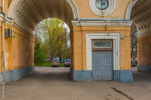 architecture of the entrance arch to the courtyard of a multi-storey building built in 1936 in the industrial settlement of Sotsgorod in the city of Novocherkassk (South of Russia) on a spring day © Alexei Merinov
