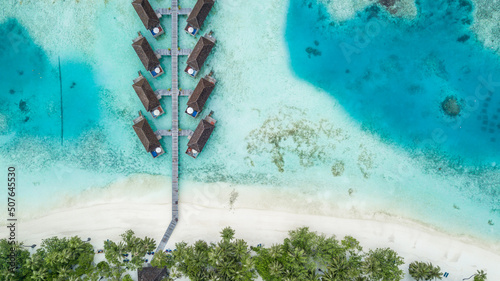 Aerial view beautiful beach forest ocean sea, Tropical island resort and emerald clear water, Tropical island with resort pool villa and turquoise clear water coral reef, Maldives