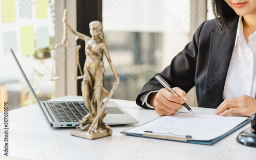 Fotografie Lady of justitia with lawyer woman working with contract.