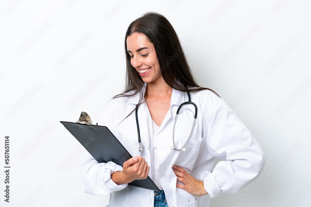 Young caucasian woman isolated on white background wearing a doctor gown and holding a folder