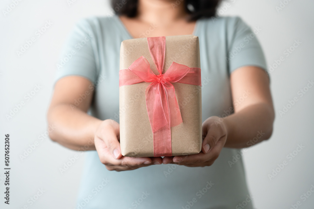 Woman carrying gift paper box tie cute ribbon for special occasion. Delivery sending present to someone special to thank or surprise. Woman carrying gift paper box tie cute ribbon for special occasion. Delivery sending present to someone special to thank or surprise.