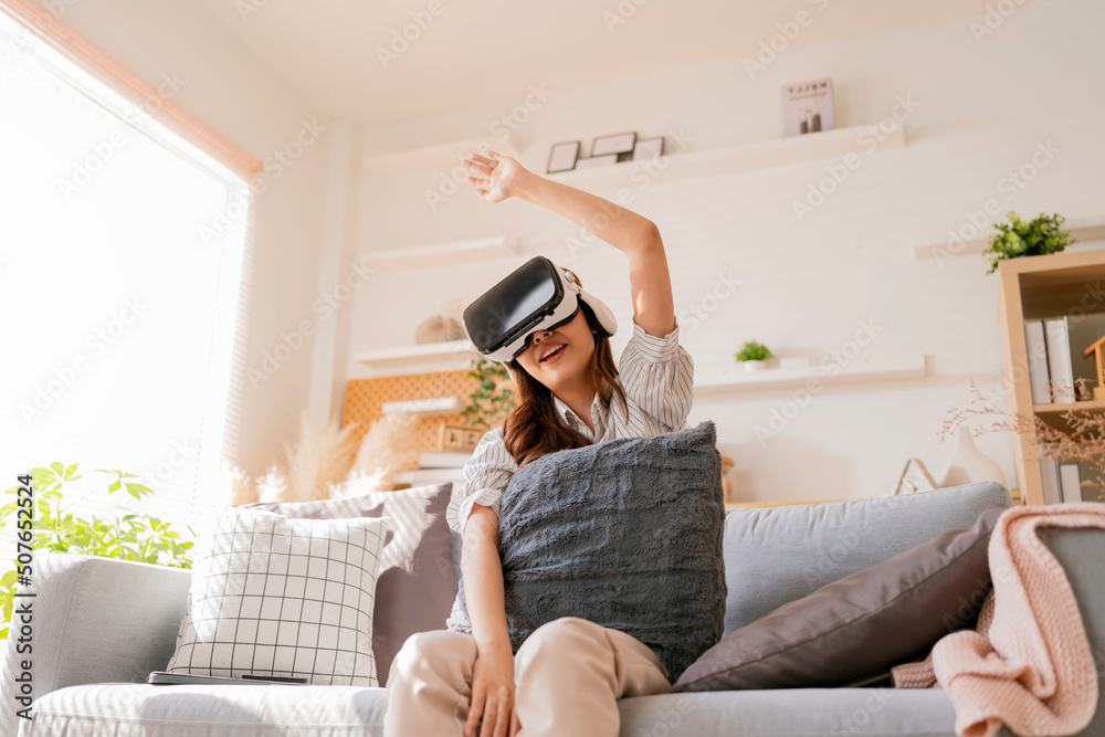 happiness exited asian female teen hand wave along with her virtual concert performance via virtual goggle virtual interactive headset,asia woman stay home innovation technology lifestyle vr at home