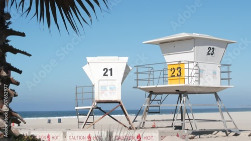 Lifeguard stand and palm tree, life guard tower for surfing on California beach. Summer pacific ocean in USA aesthetic. Iconic rescue baywatch station, coast lifesavers wachtower hut or house by sea.