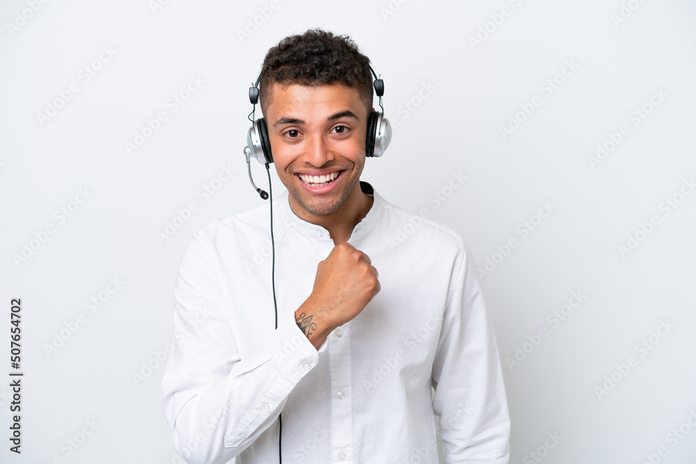 Telemarketer Brazilian man working with a headset isolated on white background celebrating a victory Telemarketer Brazilian man working with a headset isolated on white background celebrating a victory