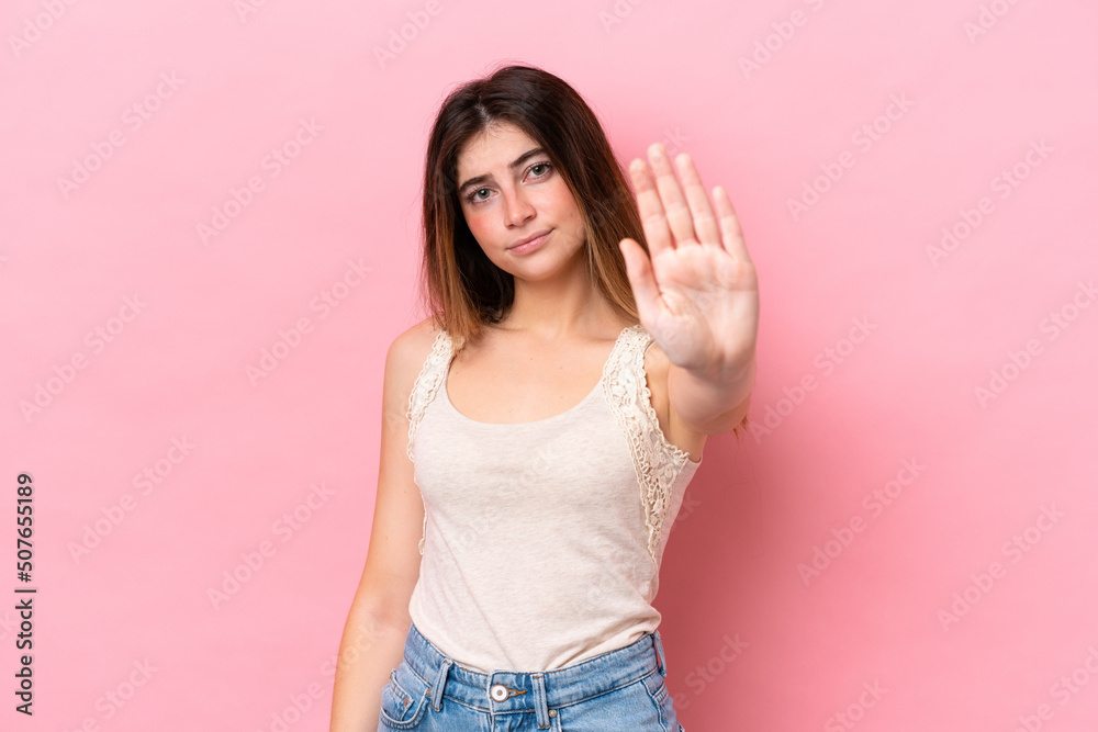Young caucasian woman isolated on pink background making stop gesture Young caucasian woman isolated on pink background making stop gesture
