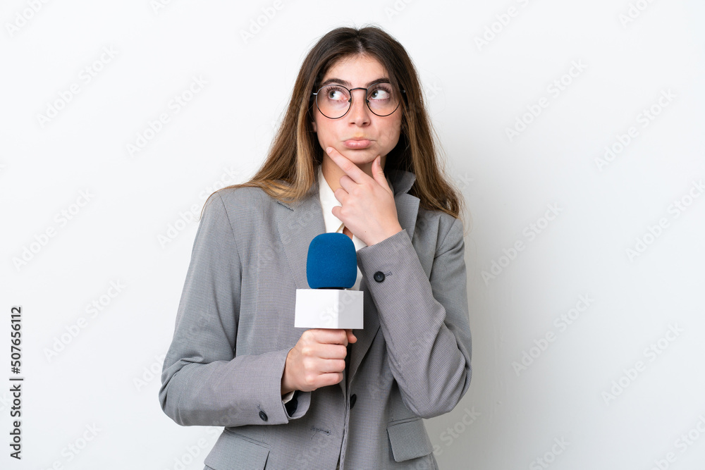 Young caucasian TV presenter woman isolated on white background having doubts