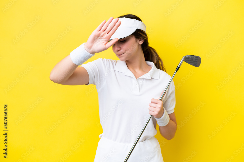 young caucasian woman playing golf isolated on yellow background making stop gesture and disappointed young caucasian woman playing golf isolated on yellow background making stop gesture and disappointed