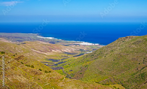 Beautiful view from montain top on valley, serpentine road, blue sea, white village - Majanicho, North Fuerteventura