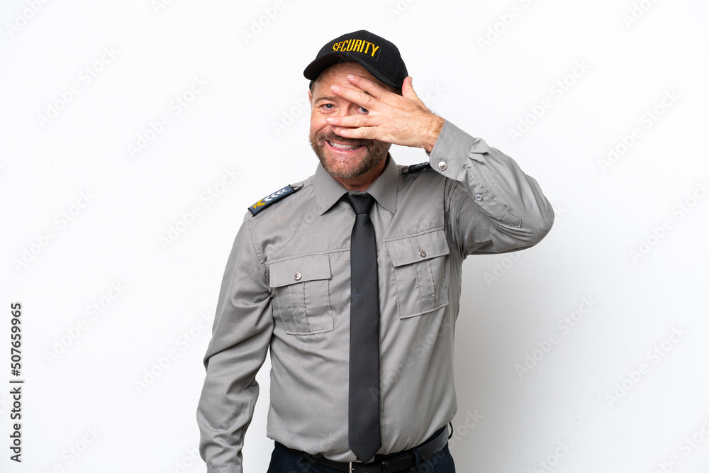 Middle age security man isolated on white background covering eyes by hands and smiling Middle age security man isolated on white background covering eyes by hands and smiling
