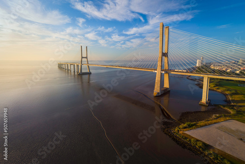 Fotografija Vasco da Gama bridge over tagus river in Lisbon, Portugal, at sunrise, aerial (d