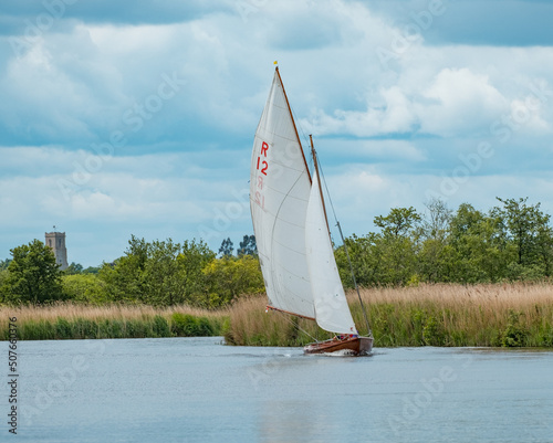 Horning, Norfolk, UK – May 28 2022. A Rebel sailing boat on the River Bure leg of the 2022 annual Three Rivers Race held in the Norfolk Broads photo