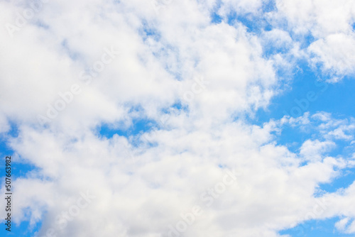 White cumulus clouds in a blue sky