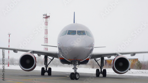 Plane rides on runway. Stock footage. Plane is preparing for takeoff moving along runway in winter. Plane on runway before flying abroad for vacation