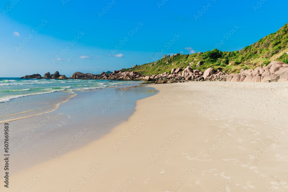 Wild beach with rocks and ocean waves. Holiday banner in Brazil