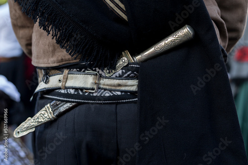 Rear view in detail of the traditional belt and knife (facon) of an Argentine gaucho. Close-up, unrecognizable person. Concept Argentine Culture and Traditions