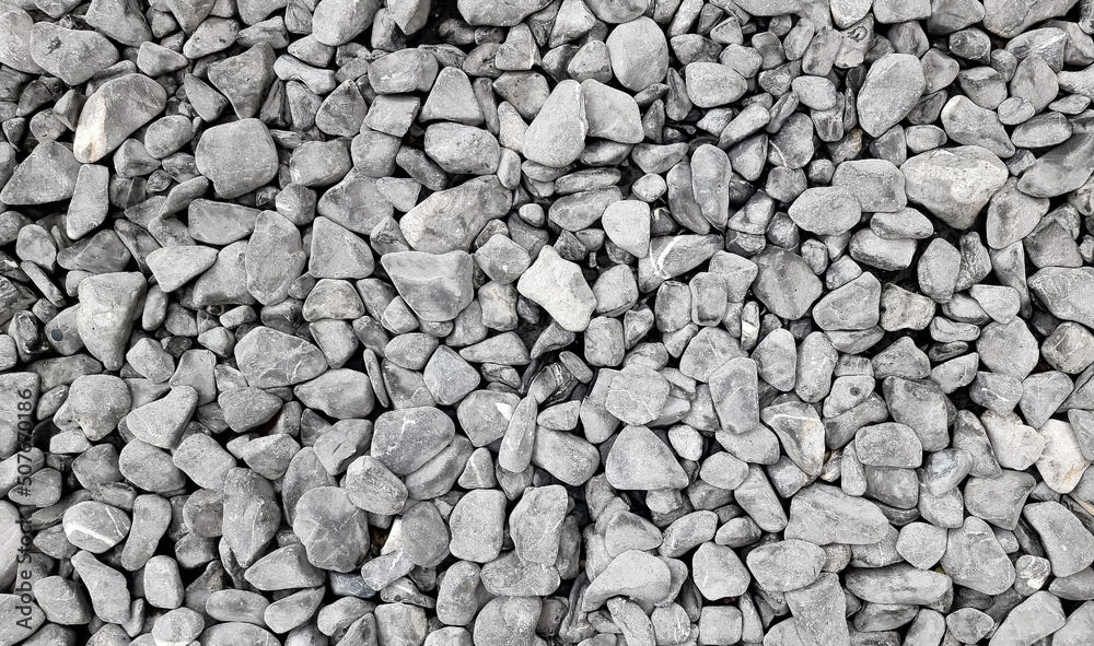 background made of a close up of a pile of crushed stone. grungy pebble stones for exterior flooring covering use as background. pile of small loose decorative garden path stones. background made of a close up of a pile of crushed stone. grungy pebble stones for exterior flooring covering use as background. pile of small loose decorative garden path stones.