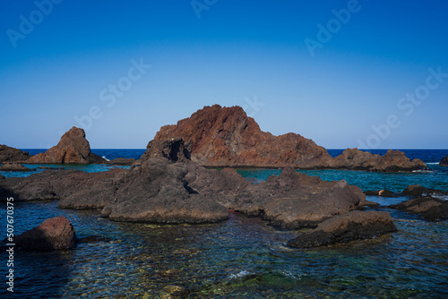 View of the lava beach of Linosa Called Faraglioni