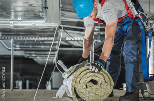 Worker with Piece of Mineral Wool Insulation photo