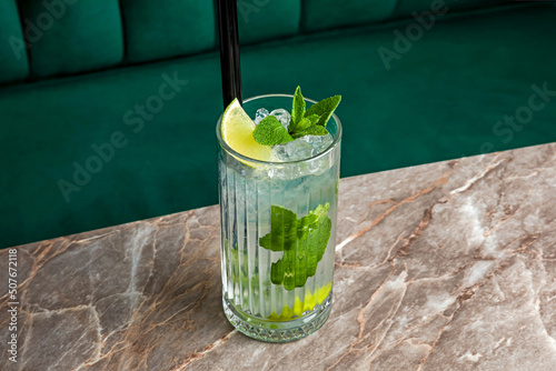 Fotografia Mojito rum alcoholic cocktail served in a highball glass with ice cubes garnishe
