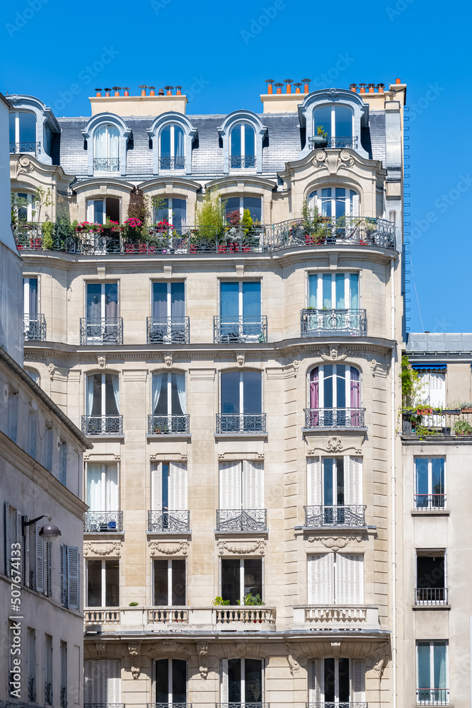 Paris, typical facade boulevard Magenta, beautiful building, with old zinc roofs
