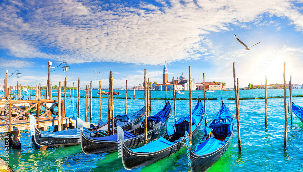Traditional Gondolas moored on the Pier in the Grand Canal by San Giorgio Maggiore, Venice, Italy