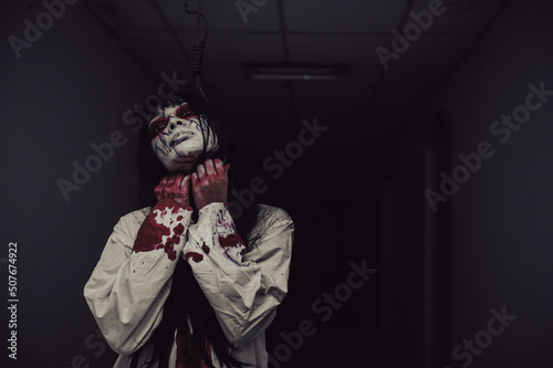 Fototapeta Naklejka Na Ścianę i Meble -  Portrait of asian woman make up ghost,Scary horror scene for background,Halloween festival concept,Ghost movies poster,angry spirit in the apartment