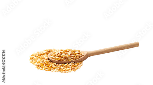 dried peas crumble from a wooden spoon isolated on white background.
