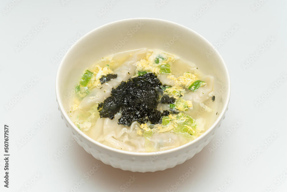 Delicious looking dumpling soup served in a bowl Delicious looking dumpling soup served in a bowl