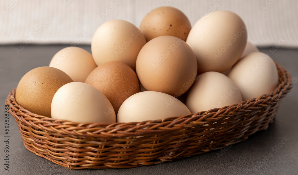 Farm chicken eggs. Lots of eggs in a wicker basket close up. Farm chicken eggs. Lots of eggs in a wicker basket close up.